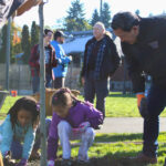 Mayor Harrell with kids planting