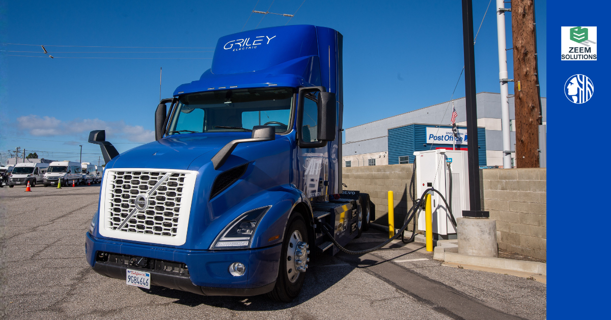 Picture of blue electric drayage truck plugged into a charging station. Also includes the logos for Zeem and city of Seattle.