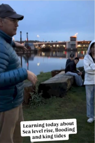 David in front of the Duwamish River at dawn with dozens of youth talking about flooding, sea level rise, and king tides. 